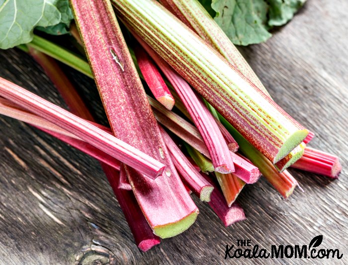Cut rhubarb on a wooden table, ready to be bakes into a Grandma's rhubarb pie or other delicious recipes.