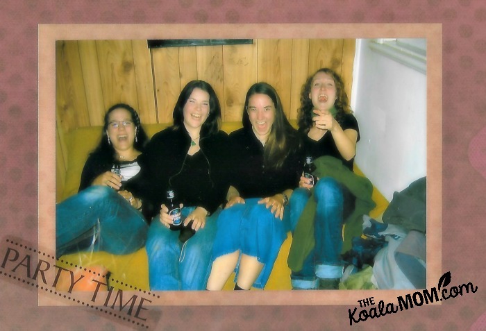 Four girls in black tops and jeans partying with green apple wine