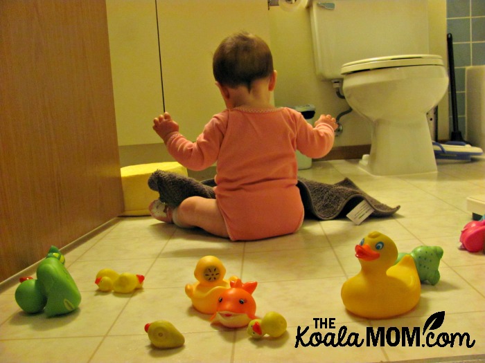 Lily playing with her bath duckies