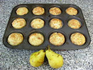 picture of muffin tray with pear cardamon muffins