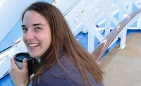 Bonnie Way holding a stainless steel coffee mug on a cruise ship