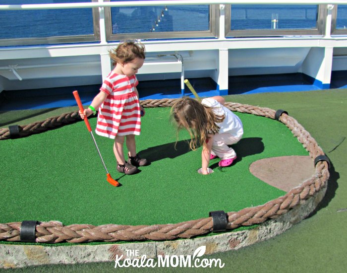 Sunshine and Lily playing mini golf on the Carnival Splendor.