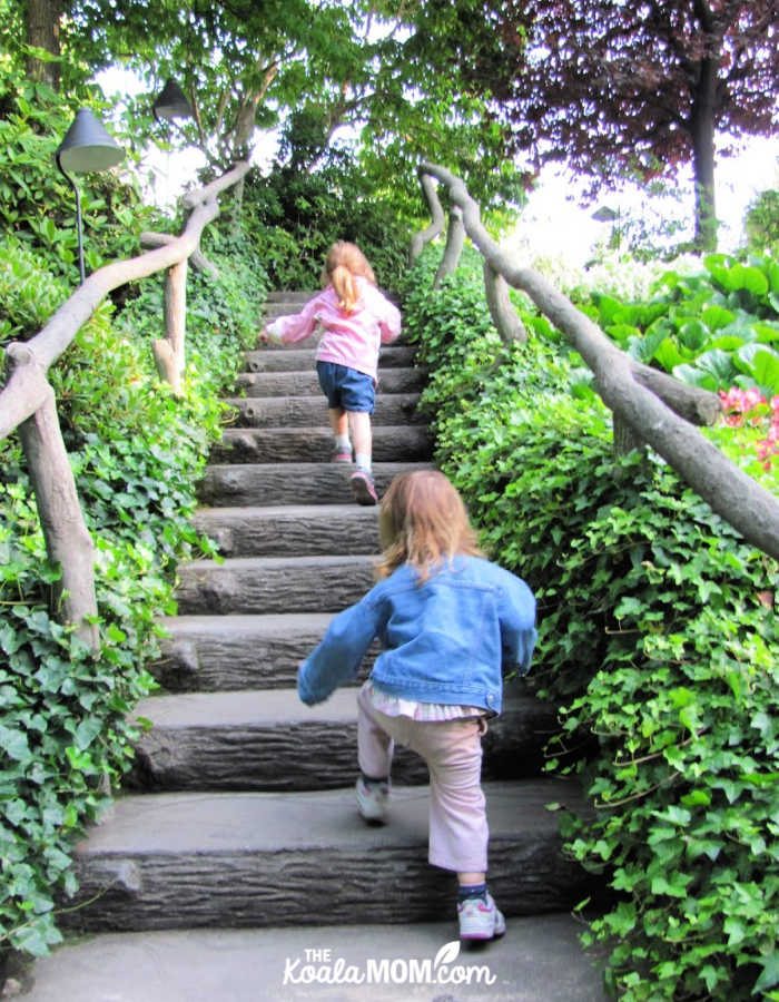 Sisters climbing the stairs to explore the garden.