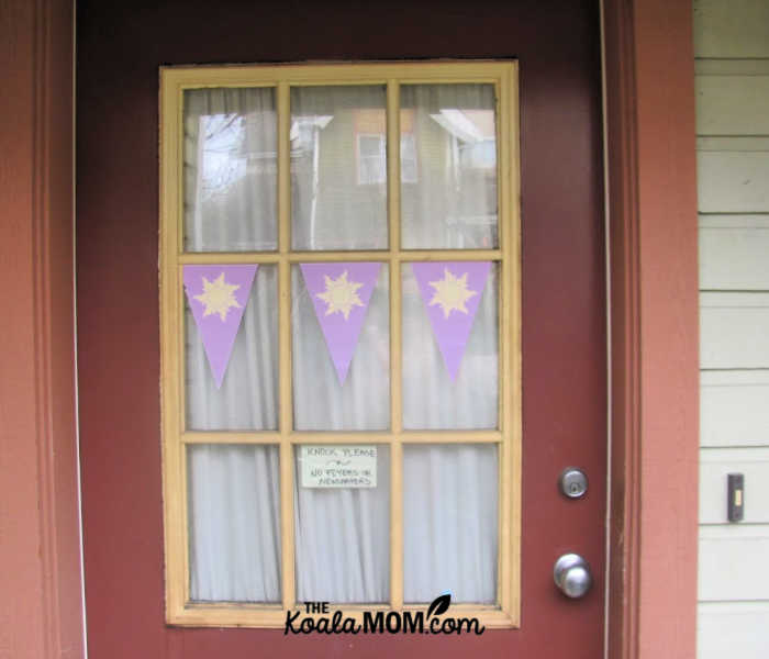 Disney Tangled birthday party decorations on a front door.