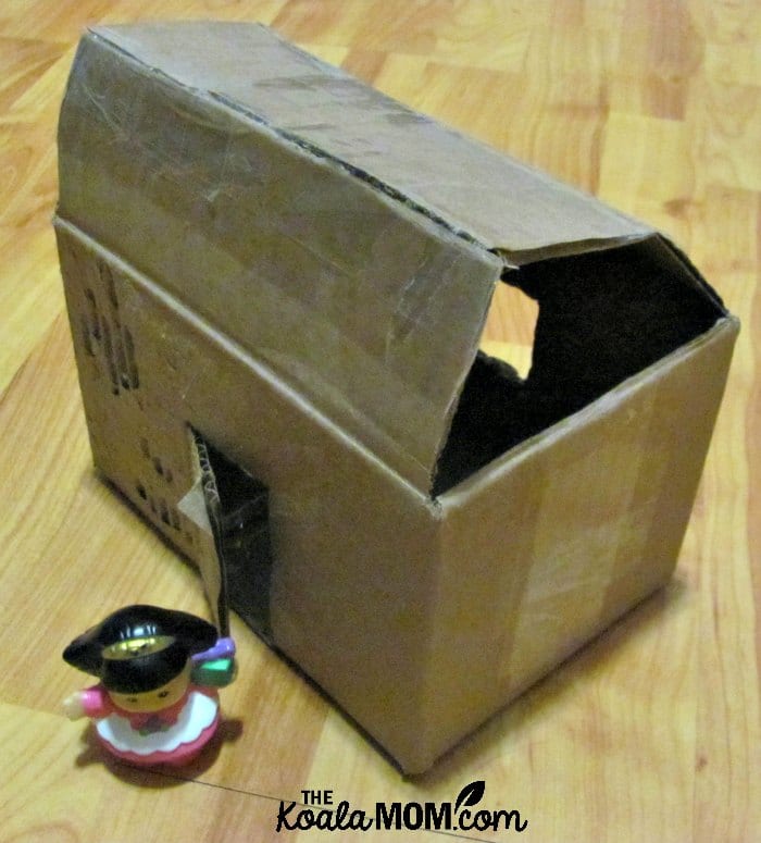 Small cardboard box house for Little People or dolls.