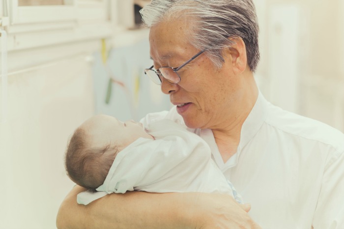 Pastor Lee Jong-rak holds a baby