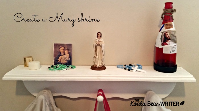 Sunshine's Mary shrine includes a statue of Mary, a candle, rosaries, and a prayer card.