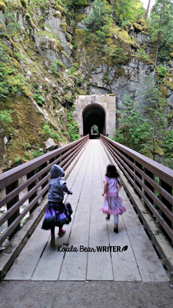 Girls running across the Othello Tunnels bridge