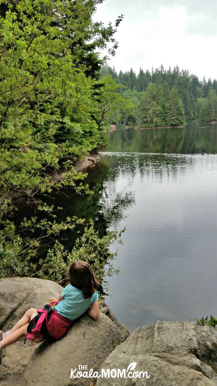 Lily sitting on a rock by Rice Lake, BC