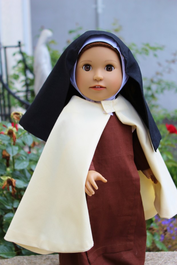 St. Therese doll with outfit and book in the Dolls from Heaven collection