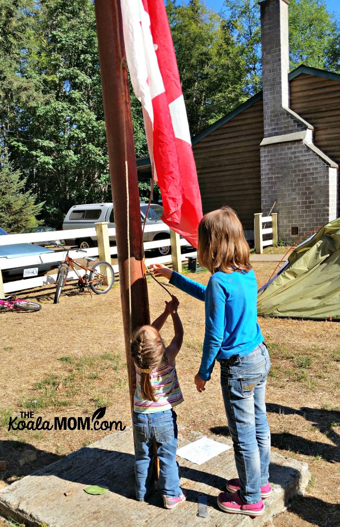 Jade helps raise the flag at homeschool camp