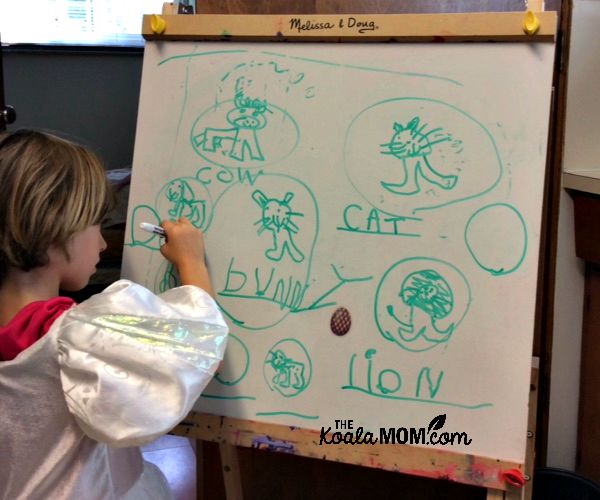 Child writing at a whiteboard