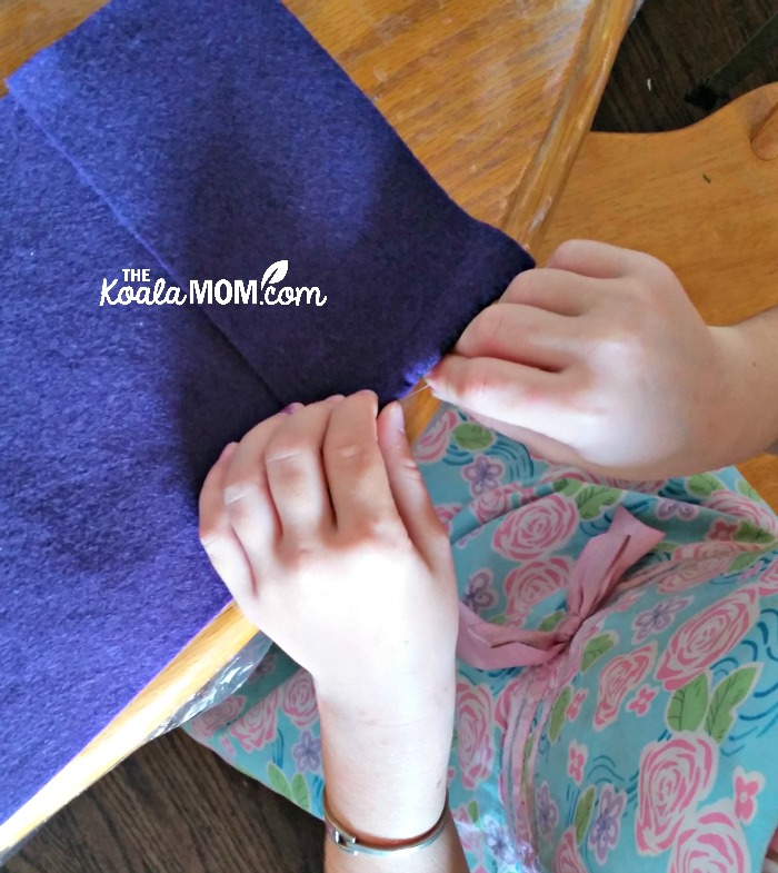 Sunshine sewing her felt notebook case