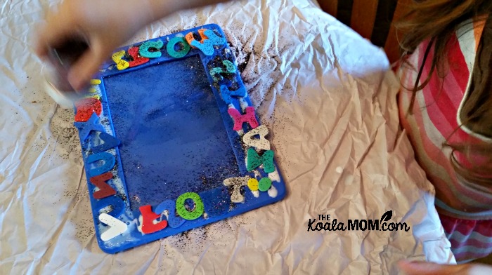 Adding alphabet stickers and glitter to a photo frame