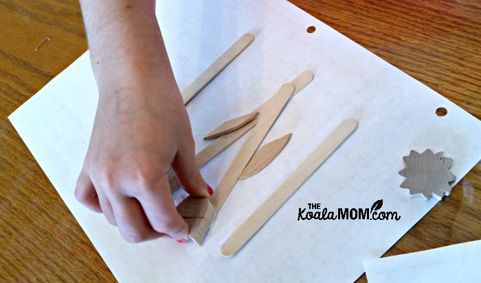 Lily gluing plant markers together