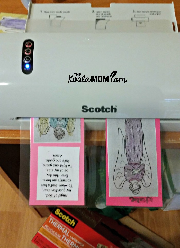Laminating our guardian angel prayer cards with our Scotch Thermal Laminator