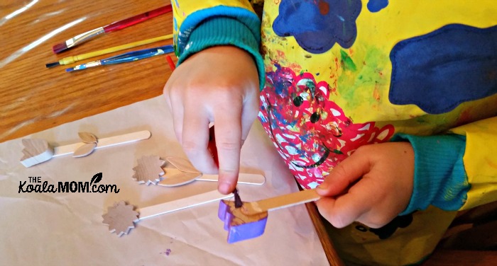 Lily painting her plant markers