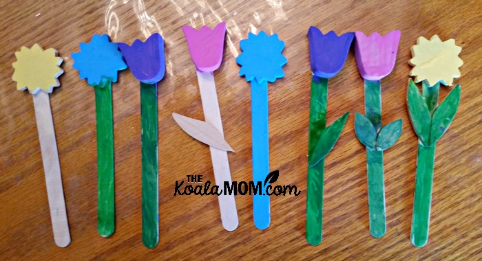 Painted plant markers, made from craft sticks and wood flower cutouts