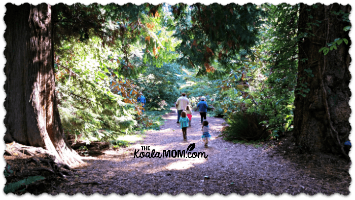 Family group walking through UBC Botanical Gardens
