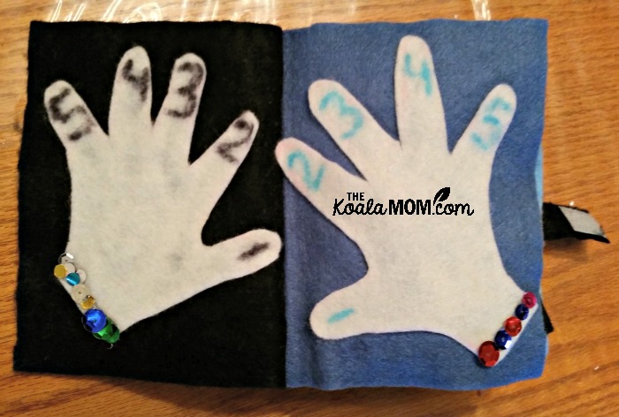 Quiet Book: child's hands, with sequin bracelets and numbered fingers