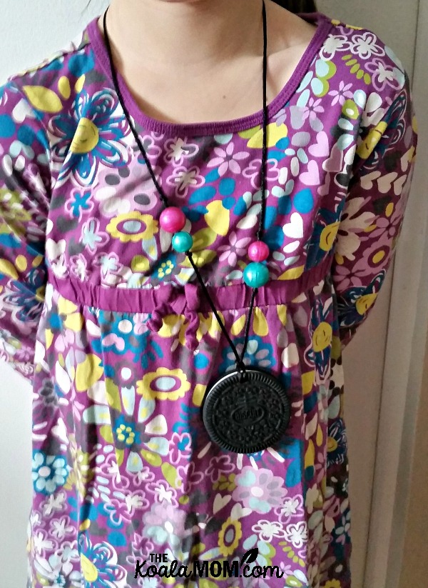 Lily wearing her chewelry, a sensory necklace for kids