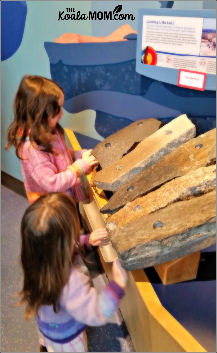 Girls tapping rocks at Telus World of Science