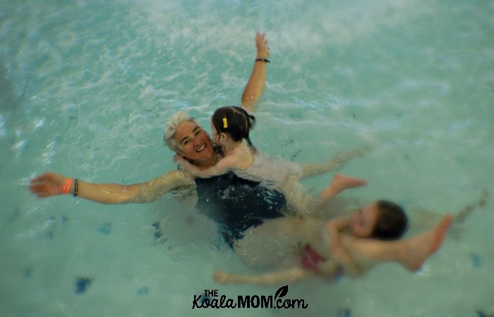 Grandma having fun swimming with two girls