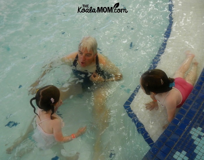 How to help your children love swimming - play games like tea parties and blowing bubbles at the pool