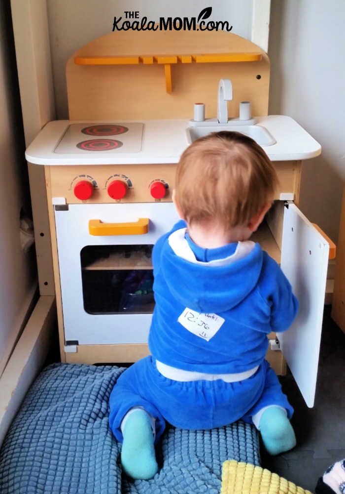 Boy playing in a toy kitchen at Circus Play Cafe in East Vancouver.