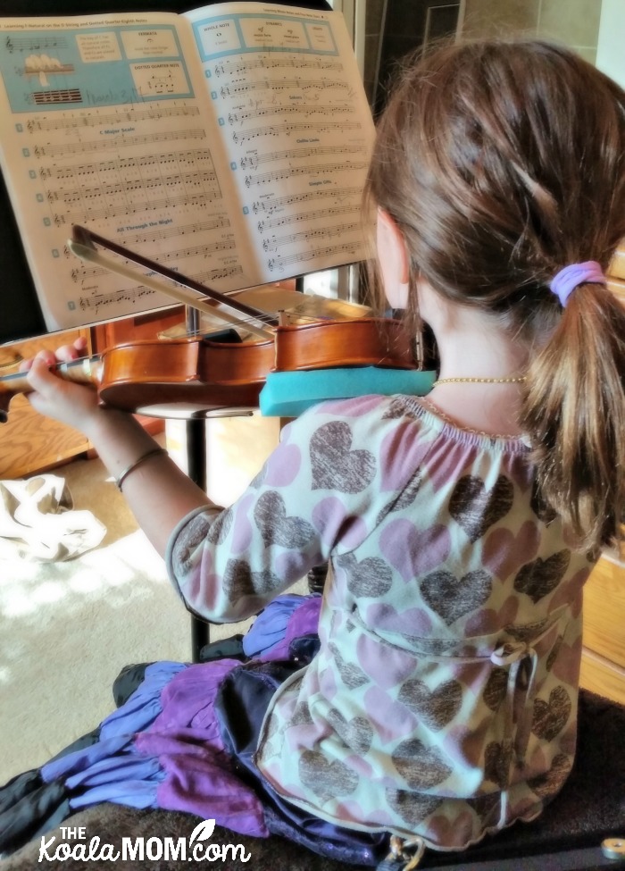 Sunshine playing violin before her weekly violin lessons
