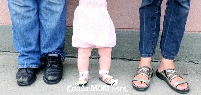 Mommy and Daddy with baby between (just their feet) - photo by Memotime Photography