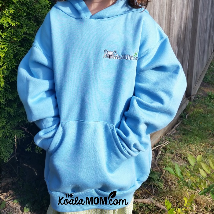 School clothing from Bravo apparel - a blue girls' hoodie with the Koala Mom logo on it