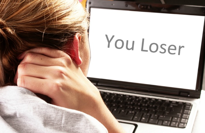 Girl facing cyber bullies via her laptop