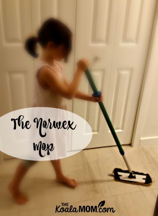 6-year-old sweeping the floor with the Norwex mop