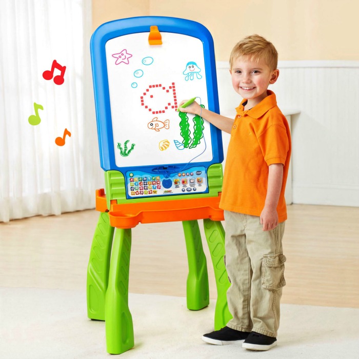 Boy drawing at a DigiArt Creative Easel, one of the VTech toys on my Christmas gift guide