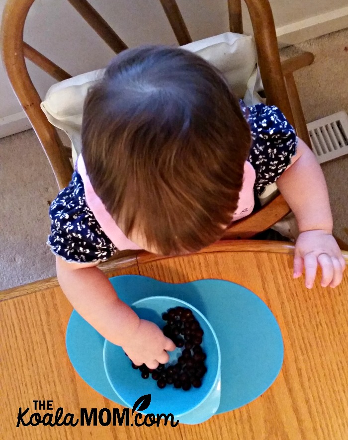 Baby feeding herself with Tommee Tippee's mealtime products