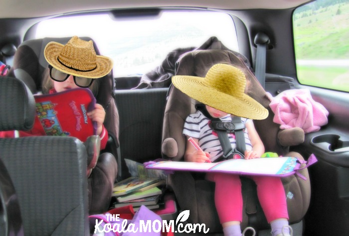 Girls colouring with Aquadoodles in the back of a vehicle