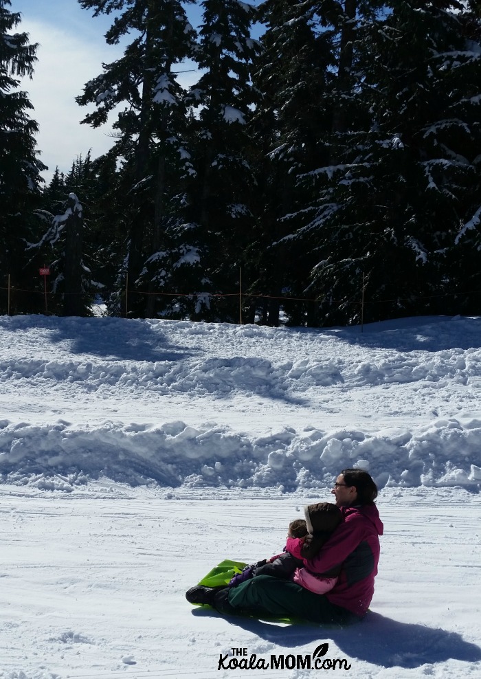 Bonnie Way riding a crazy carpet at Mount Seymour with her youngest two daughters