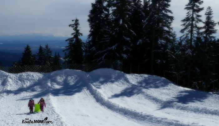 Sisters sledding at Mount Seymour