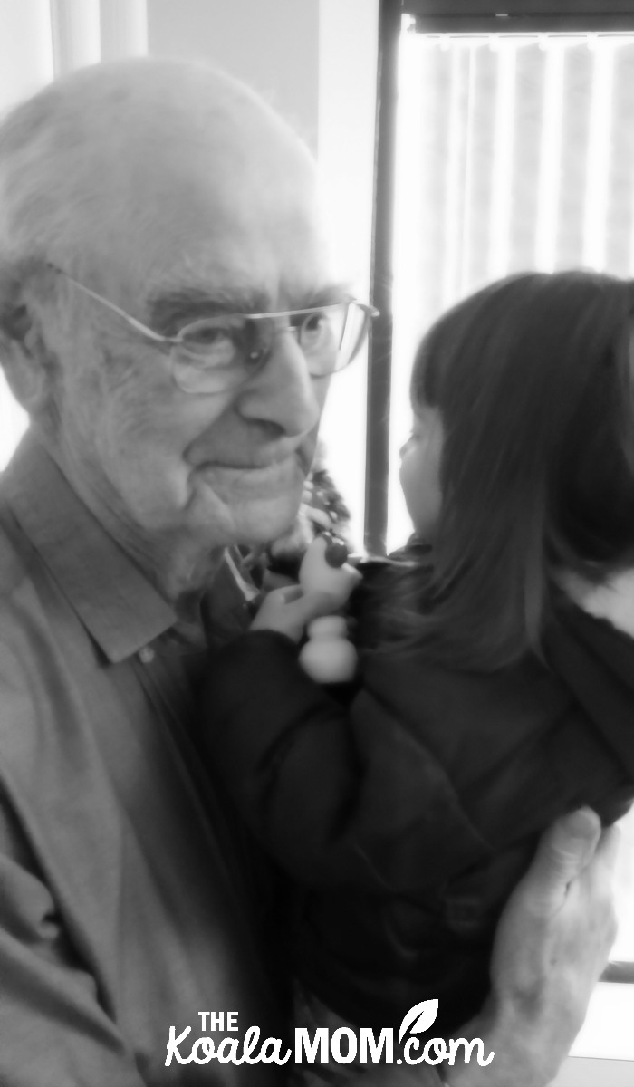 Grandpa holding his great-granddaughter: grandpa's legacy is the importance of family