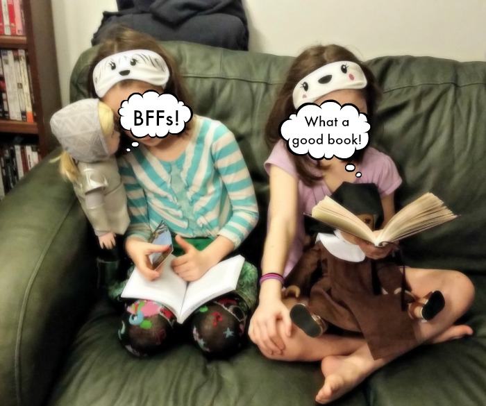 Sunshine and Lily reading with their saint dolls