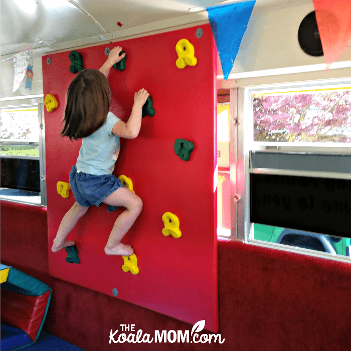 Toddler climbing a wall in the Vancouver Tumblebus