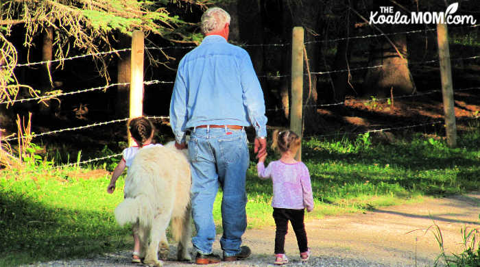 Girls walking the dog with Grandpa.