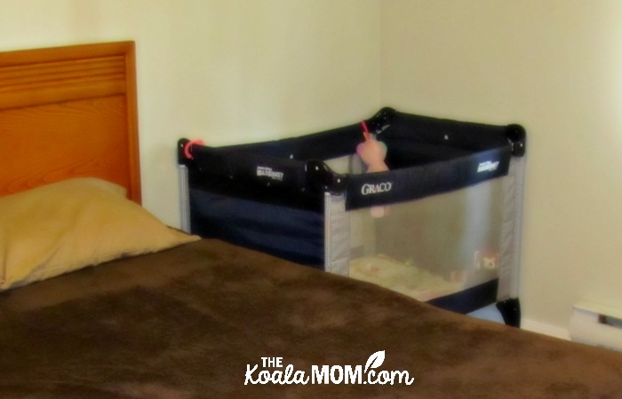 Graco playpen next to a queen bed