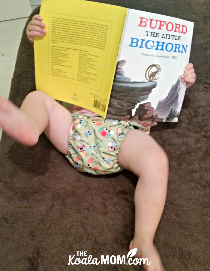 Omaiki cloth diaper on a baby reading a Bill Peet book