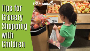 Tips for Grocery Shopping with Children. 8-year-old girl chooses apples at a grocery store.