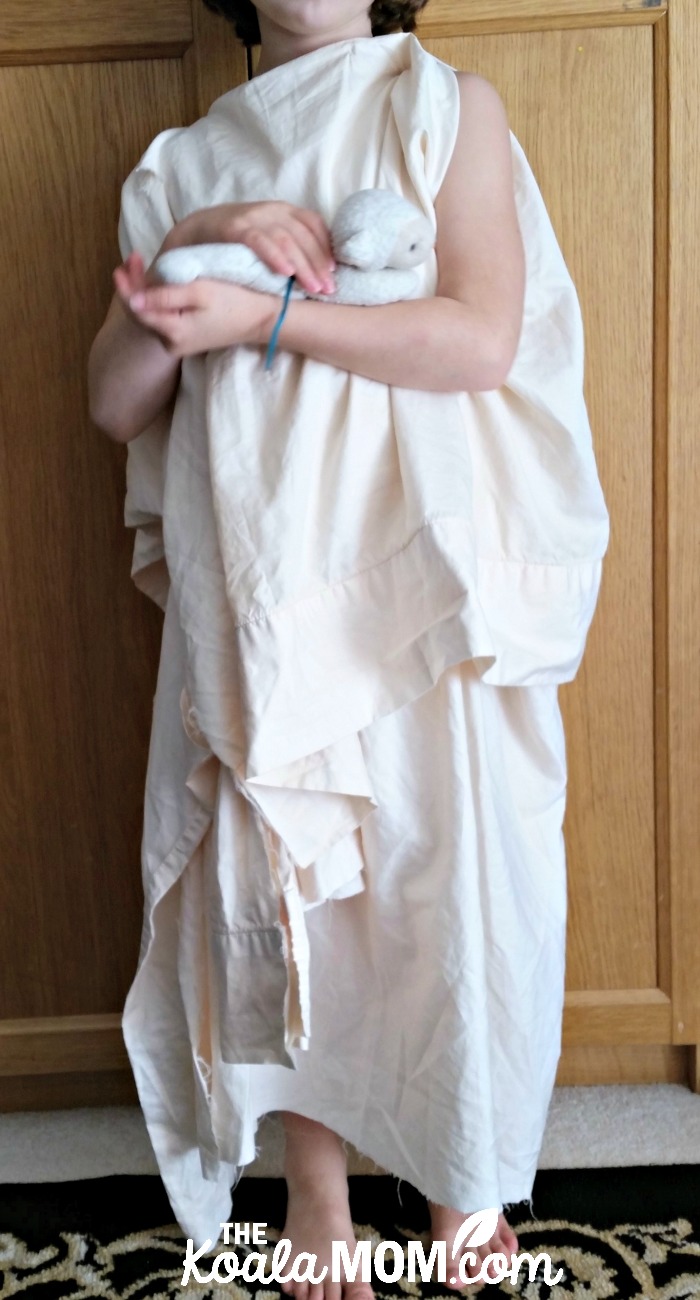 Saint Agnes of Rome costume made using a bedsheet and a stuffed lamb.