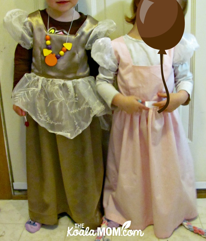 Two girls in their saint princess costumes, ready to party