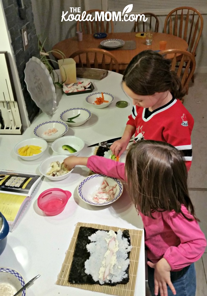 Jade and Lily assemble their sushi rolls