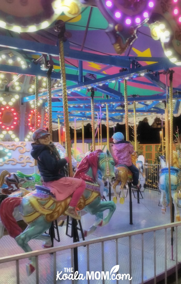 Girls riding the carousel at the Vancouver Christmas Market